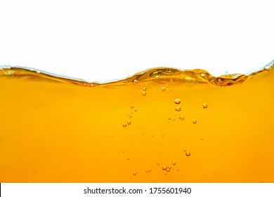 Closeup process of splashing of green tea. Macro shot of liquid in transparent glass. Abstract background with splashes, sprays, waves, bubbles of lager beer, whiskey, cognac, rum, brandy.  - Powered by Shutterstock