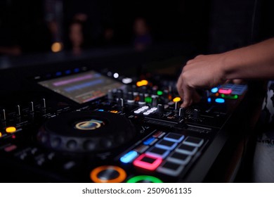 Close-up of a professional audio mixing console with glowing knobs and buttons in a recording studio. - Powered by Shutterstock