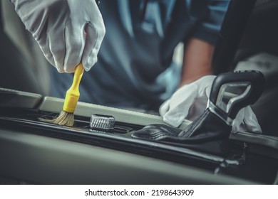 Closeup of Professional Auto Detailing Tool for Interior Cleaning Being Used by Vehicle Detailer to Remove Dust From Controllers Around Automatic Transmission.