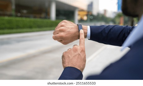 Closeup of professional businessman hand show smart watch and pointing the times. Professional boss, ceo, leader checking time from top view with city view. Business. Blurred background. Exultant. - Powered by Shutterstock