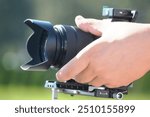 Close-up of a professional camera in the hands of a cameraman