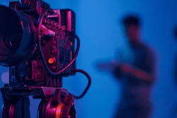 Close-up Of Professional Camera Setting For Shooting With Operator Working In Background