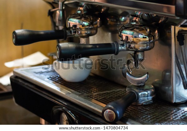 Closeup, professional coffee machine with\
bottomless filter