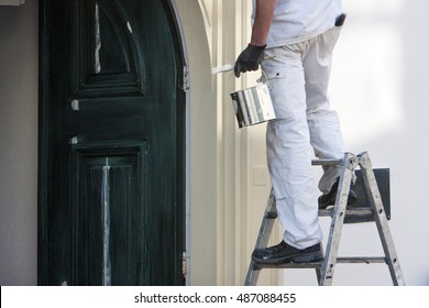 Closeup Of A Professional House Painter With Paint And Brush