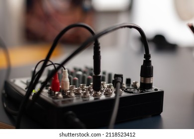 Closeup Of Professional Recording Instrument On Desk. Audio Mixer For Live Broadcast. Podcast Electronic Console In Home Studio. Broadcasting Mixing Desk Station Used To Record Sound And Dubbing.