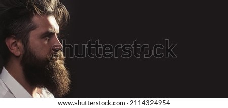 Closeup profile of bearded man with classic black long beard, bearded gay. Barber barbershop. Mustache men, serious face close up. Templates web banner design. Banner for website.