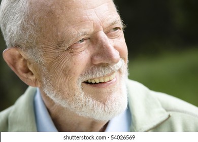 Closeup Profile On A Smiling Old Man With A Grey Beard