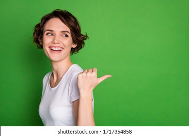 Closeup Profile Photo Of Funny Attractive Lady Wavy Hairdo Direct Thumb Finger Side Empty Space Offer Cool Sale Shopping Prices Wear Casual White T-shirt Isolated Green Color Background