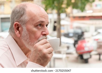 Close-up Profile Portrait Of An Older Man Drinking His Cup Of Coffee Or Tea