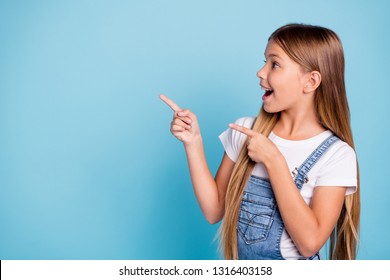 Close-up profile side portrait of her she nice cute attractive cheerful amazed glad straight-haired blonde girl pointing two fingers looking aside copy space isolated on blue pastel background