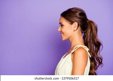 Close-up profile side view portrait of nice adorable well-groomed attractive stunning lovable fascinating magnificent winsome content cheerful cheery wavy-haired girl isolated over violet background