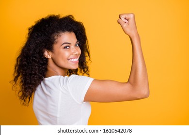 Close-up profile side view portrait of her she nice attractive lovely brunet cheerful wavy-haired girl showing strong muscles isolated over bright vivid shine vibrant yellow color background - Shutterstock ID 1610542078
