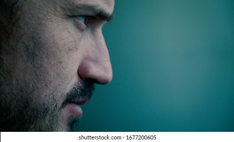 Close-up profile side view portrait of nice lovely classy elegant content handsome attractive tired bearded man in suit isolated over dark green background. determined man portrait