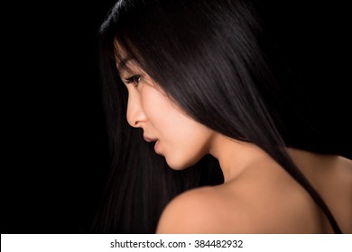 Close-up Profile Of Young Asian Lady Demonstrating Black Hair. Back View Of Beautiful Woman Looking Away And Showing Her Gorgeous Hair In Studio.