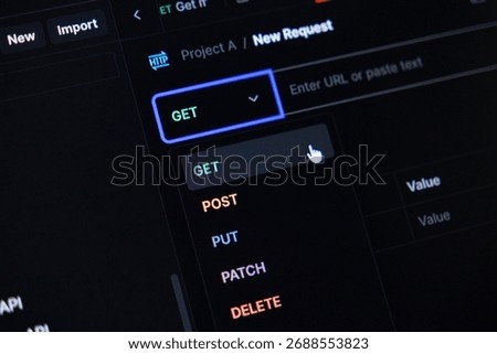 Close-up of a programmer using an API client, selecting the GET method from a dropdown with HTTP operations like POST, PUT, PATCH, DELETE for backend data interaction
