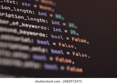 Close-up of programming code on a screen, highlighting syntax with various data types and boolean settings.