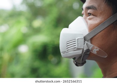Close-up of protective face mask used by farmer during pesticide or chemical spraying. The mask helps prevent inhalation of toxic substances. Concept safety and health in agricultural environments.  