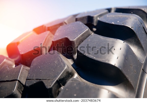 Closeup protector of black tires for\
dump trucks for transporting ore or coal from\
mines.