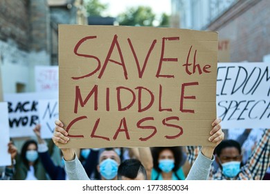 Close-up Of Protester Holding A Banner With Save The Middle Class Inscription On A Protest During Coronavirus Pandemic. 