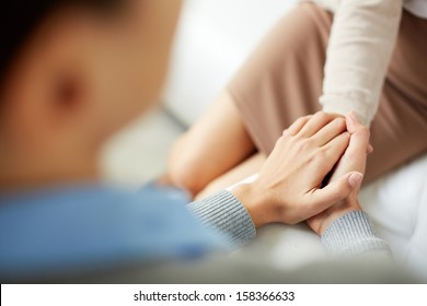 Close-up Of Psychiatrist Keeping Her Hands Together While Listening To Her Patient
