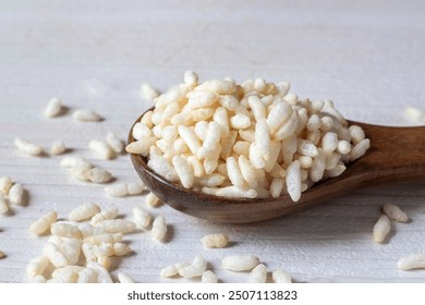 Closeup of Puffed Rice or Popped Rice on a Wooden Spoon Isolated on White Background with Copy Space, Also Known as Murmura or Muri, Indian Snack Food - Powered by Shutterstock