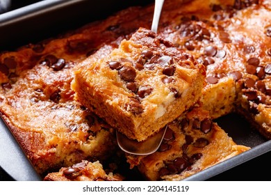 Close-up Of Pumpkin Chocolate Chips Sheet Cake Cut In Slices In A Baking Dish On Dark Concrete Table, Landscape View