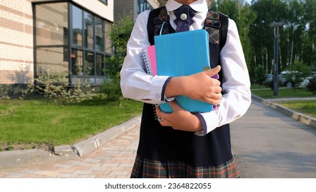 Close-up of pupil with notebooks going to classes in the morning - Shutterstock ID 2364822055
