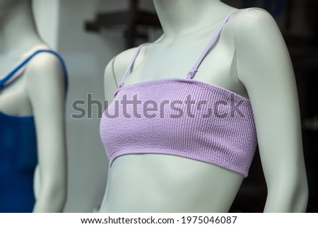 Closeup of purple bikini on mannequin in a fashion store showroom