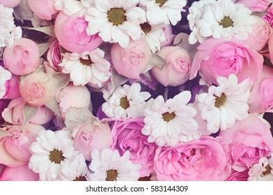 Closeup of purple roses and white daisy flowers bouquet for holiday background