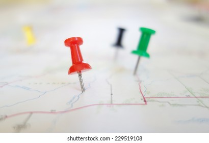 Closeup of push pin tacks in a map                               