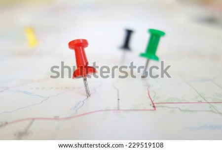 Closeup of push pin tacks in a map                               