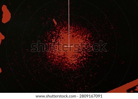 Closeup radar-style display featuring a red central heatmap and crosshair target inside concentric scan rings with scattered signal noise suggesting detection, tracking, monitoring and data visuals