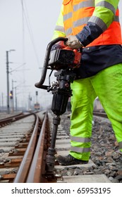 Closeup Of A Railroad Worker And A Machine