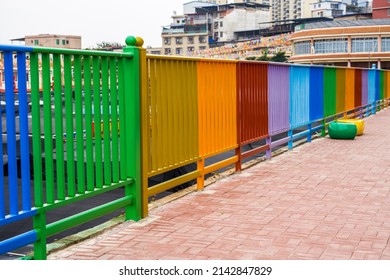 Closeup of rainbow colored railings in the city