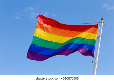 Closeup Of A Rainbow Flag On Blue Sky.