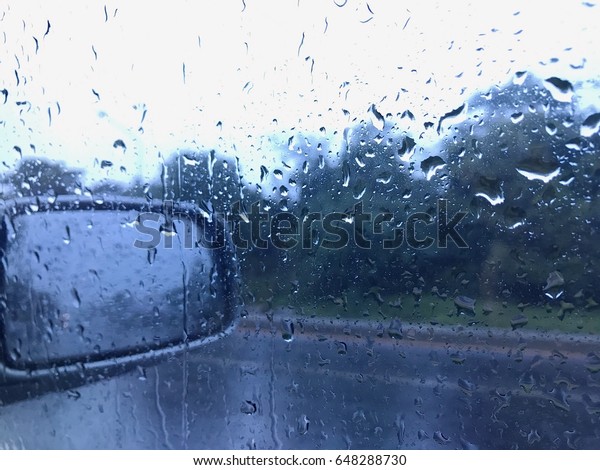 Closeup raindrop on window car glass , inside car\
view raining seasons