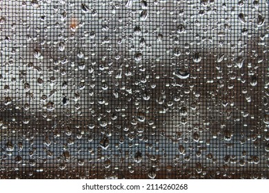 Close-up Of Raindrops Accumulated On A Wire Mesh Screen.