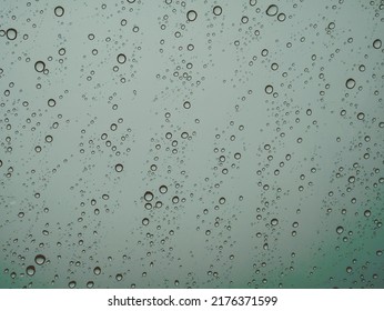 Closeup Raindrops On Glass Car In The Rainy Season.