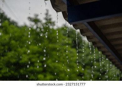 Close-up of raindrops on the roof in the rainy season. - Shutterstock ID 2327151777