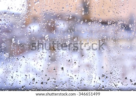close-up of raindrops on a window on a cloudy day