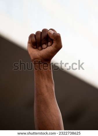 Close-up of a raised fist of an African person at a demonstration against racism.Black Lives Matters 