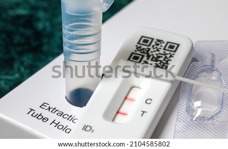 Close-up of rapid Covid-19 home lateral flow antigen test with positive result