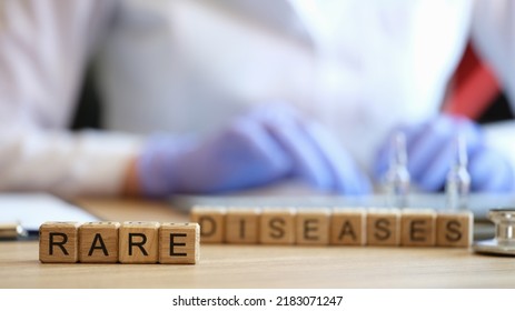 Close-up of rare disease words collected with wooden cubes. Female doctor on background. Healthcare, medicine and unusual disorders concept - Shutterstock ID 2183071247