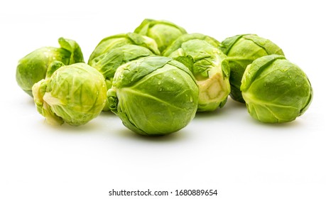 Close-up of raw, fresh and whole brussels sprouts (cabbages - Brassica oleracea). Isolated on white background.
