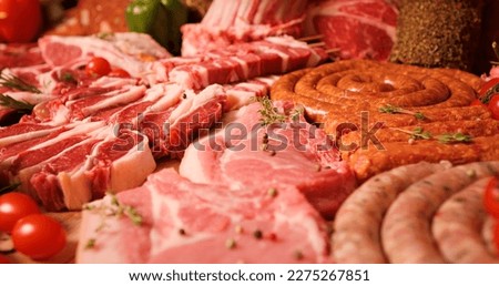 Close-up of raw meat lamb and pork cuts on the table in meat industry. Butchered beef meat ready for restaurant cooks.