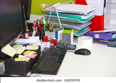 Close-up Of Real Life Messy Desk In Office