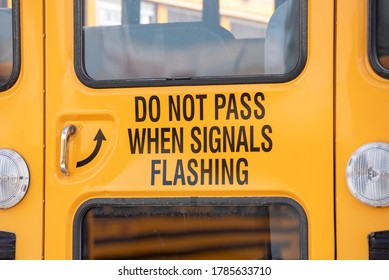 Closeup Of Rear Door Of Yellow School Bus With Do Not Pass Sign.