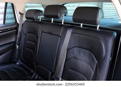 Close-up of the rear seats. Clean after washing the rear passenger seats of matte black genuine leather inside the interior of an expensive luxury suv. Preparation before selling the car.