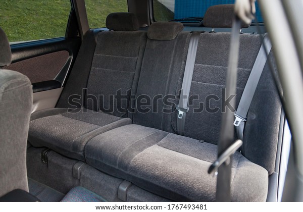 A close-up\
of the rear seats with light fabric upholstery in the interior of\
an old Japanese car in beige color after dry cleaning with rugs.\
Presale preparation in car\
service.