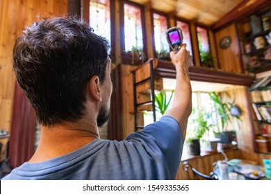 A Closeup And Rear View Of Male Building Inspector Carrying Out An Indoor Environmental Quality IEQ Assessment Inside A Residential Home